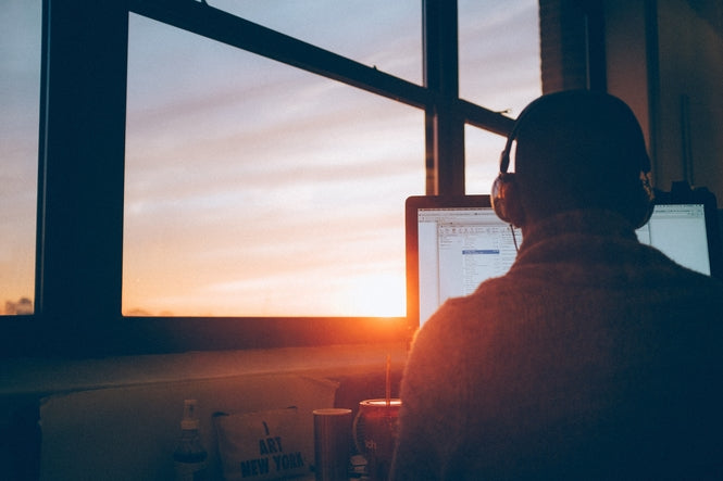 Man looking at Computer screen during overtime
