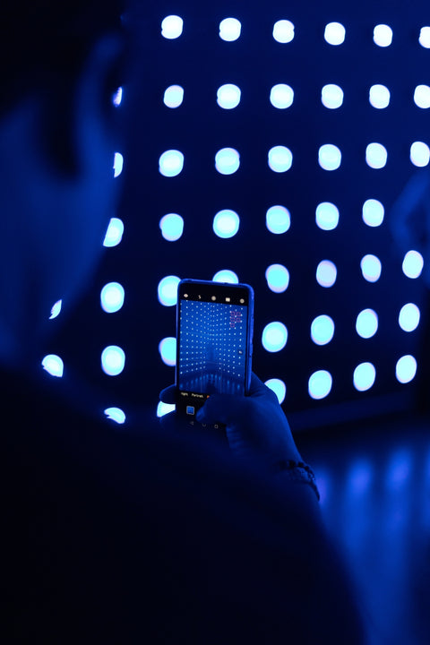 Man with a Smart phone in a blue light